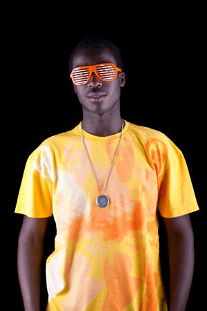 Young afro american teenager isolated over black background.