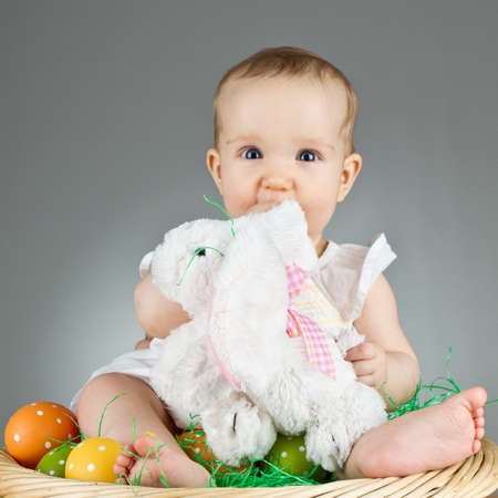 Young babay girl sitting and playing with easter egg. Very cute baby.の写真素材