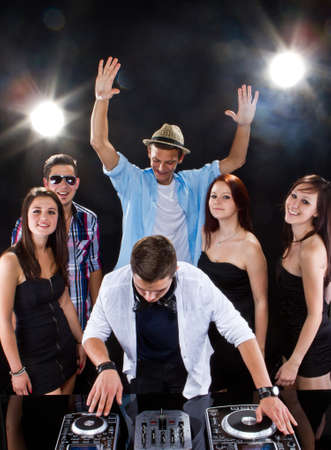 Young people partying to the music from the dj. Candid picture.