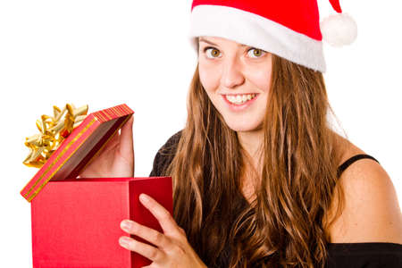 Young woman with long brown hair with a christmas hat and a present.