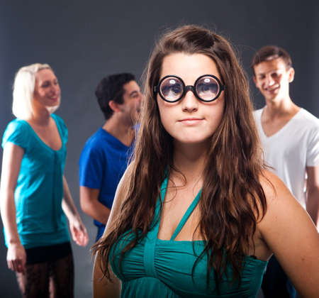 Young group of people partying with a single person in front.