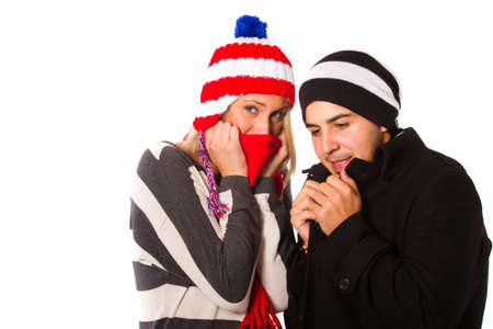Young couple with winter clothes isolated over white.の写真素材
