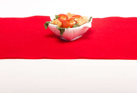 White bowl with fingerfood tomatoes filled with cheese.の写真素材