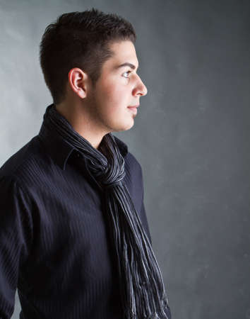 Young caucasian teenager with a scarf and stylish outfit.