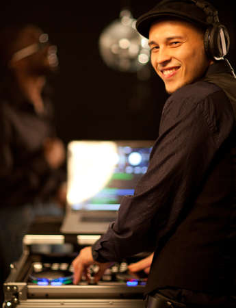 A young phillipino dj working in a club.の写真素材