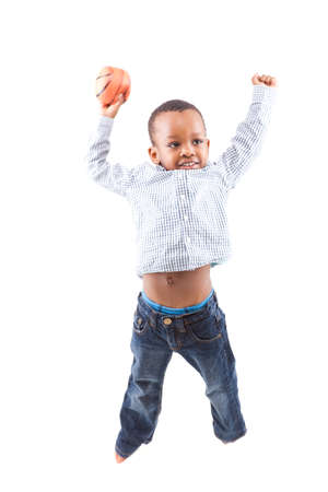 Young happy black boy isolated over a white background jumping in joy の写真素材