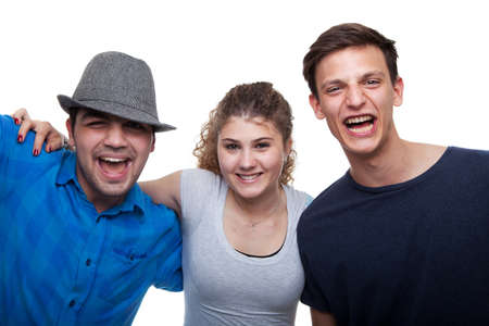 Two young men and a young woman isolated over white background.の写真素材