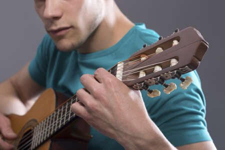 Close-up Of Young Man Playing Guitarの写真素材