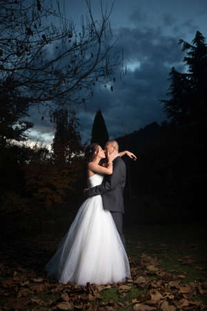 Portrait Of Young Married Couple Kissing Outdoorsの写真素材