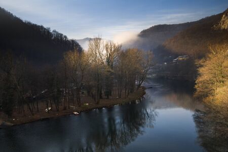View of the lake and houses along the coast and trees in the hazeの写真素材