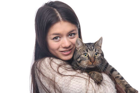 Beautiful asian teen woman with her pet in front of a white backgroundの写真素材