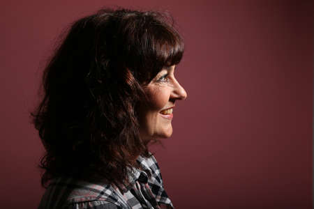 Portrait of a beautiful happy woman in front of a colored backgroundの写真素材
