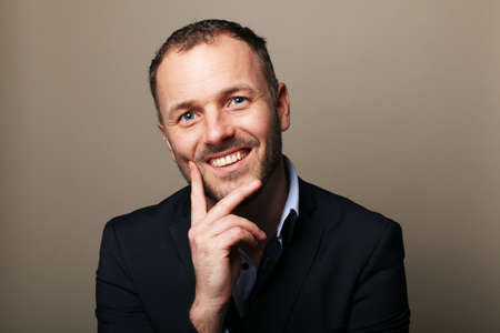 Portrait of a beautiful happy man in front of a colored background