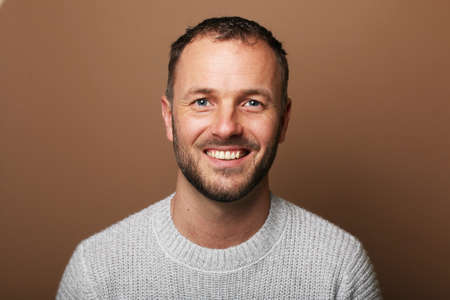 Portrait of a beautiful happy man in front of a colored backgroundの写真素材