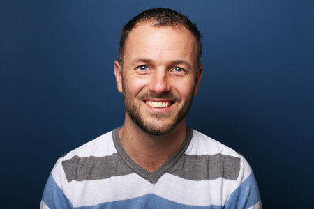 Portrait of a beautiful happy man in front of a colored backgroundの写真素材
