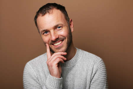 Portrait of a beautiful happy man in front of a colored backgroundの写真素材