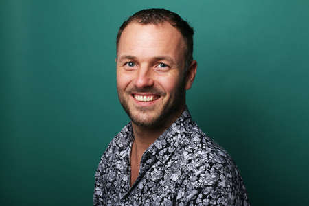 Portrait of a beautiful happy man in front of a colored backgroundの写真素材