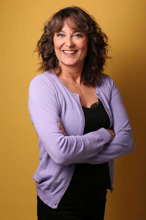 Portrait of a beautiful happy woman in front of a colored backgroundの写真素材
