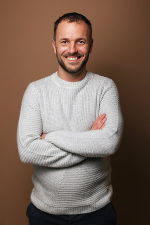 Portrait of a beautiful happy man in front of a colored backgroundの写真素材