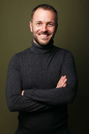 Portrait of a beautiful happy man in front of a colored backgroundの写真素材