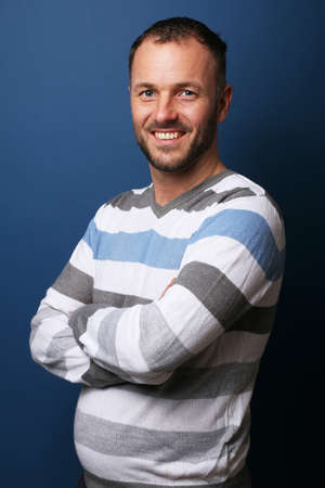 Portrait of a beautiful happy man in front of a colored backgroundの写真素材