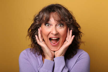 Portrait of a beautiful happy woman in front of a colored backgroundの写真素材