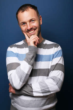 Portrait of a beautiful happy man in front of a colored backgroundの写真素材