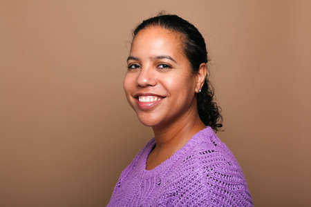 Portrait of a beautiful happy woman in front of a colored backgroundの写真素材