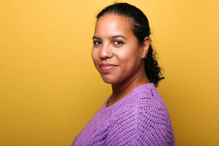 Portrait of a beautiful happy woman in front of a colored backgroundの写真素材