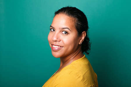 Portrait of a beautiful happy woman in front of a colored backgroundの写真素材