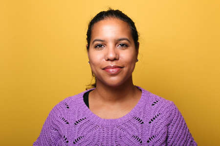 Portrait of a beautiful happy woman in front of a colored backgroundの写真素材