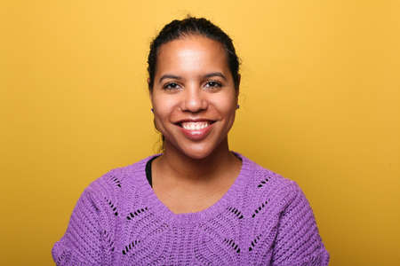 Portrait of a beautiful happy woman in front of a colored backgroundの写真素材