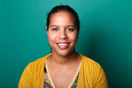 Portrait of a beautiful happy woman in front of a colored backgroundの写真素材