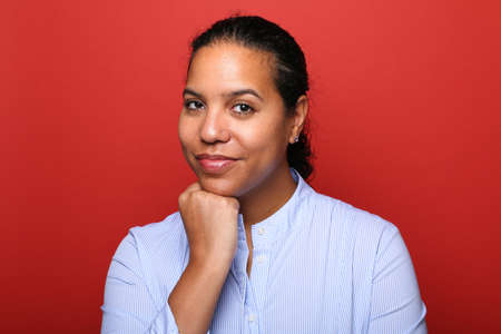Portrait of a beautiful happy woman in front of a colored backgroundの写真素材