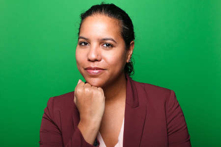 Portrait of a beautiful happy woman in front of a colored backgroundの写真素材
