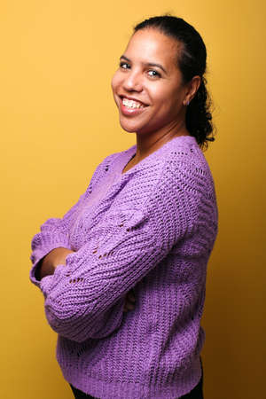Portrait of a beautiful happy woman in front of a colored backgroundの写真素材
