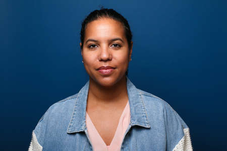 Portrait of a beautiful happy woman in front of a colored backgroundの写真素材