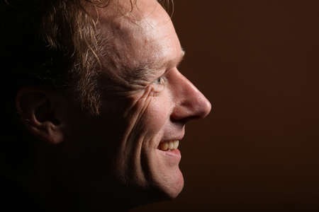 Portrait of a beautiful happy man in front of a colored background