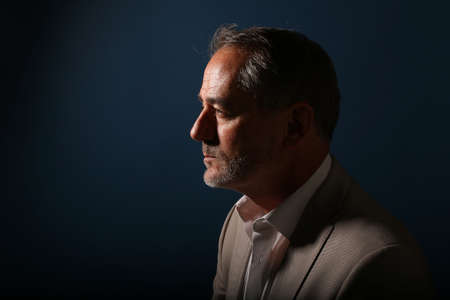 Portrait of a beautiful happy man in front of a colored background