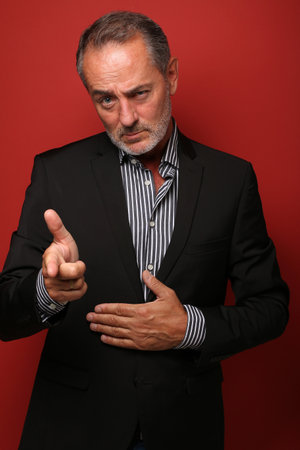 Portrait of a beautiful happy man in front of a colored backgroundの写真素材