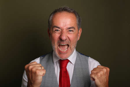 Portrait of a beautiful happy man in front of a colored background