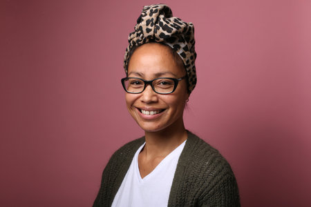 Portrait of a beautiful happy woman in front of a colored background
