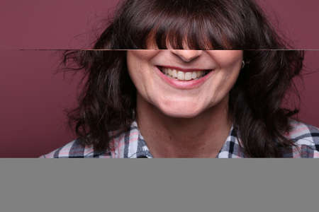 Portrait of a beautiful happy woman in front of a colored background