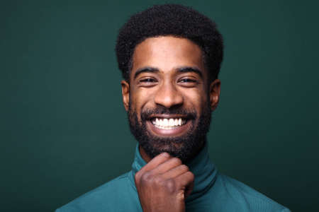 Portrait of a beautiful happy man in front of a colored background