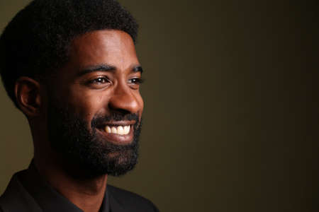 Portrait of a beautiful happy man in front of a colored background