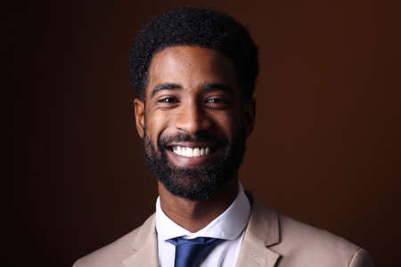 Portrait of a beautiful happy man in front of a colored backgroundの写真素材
