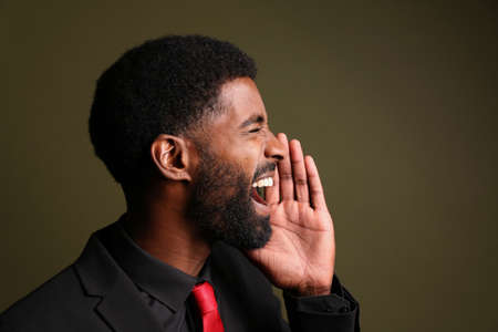 Portrait of a beautiful happy man in front of a colored backgroundの写真素材