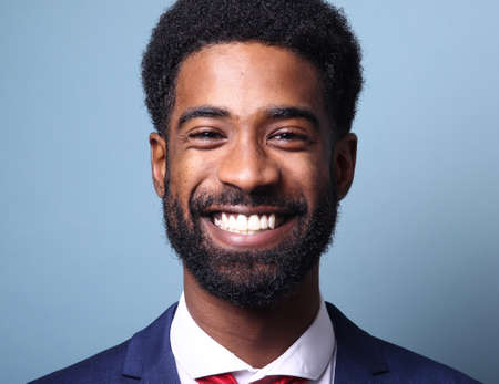 Portrait of a beautiful happy man in front of a colored background