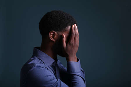 Portrait of a beautiful happy man in front of a colored backgroundの写真素材