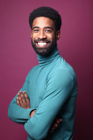 Portrait of a beautiful happy man in front of a colored backgroundの写真素材